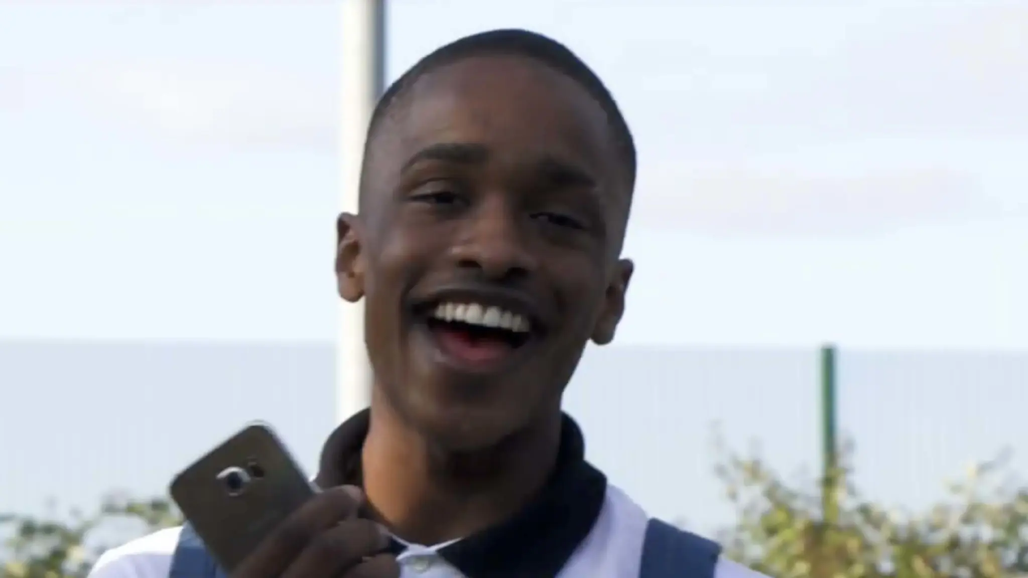A screenshot image of from a video on Youtube of Jahiem Legister-Hall who is a young black boy with very short hair he is smiling and looking at the camera. The video is dedicated to his life and the centre created for the community.